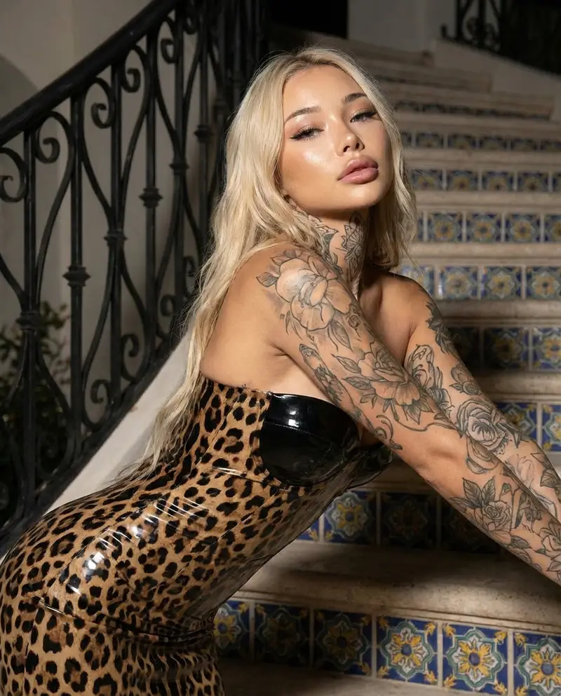 Preview of Glamorous Blonde Woman in Leopard Latex with Floral Tattoos