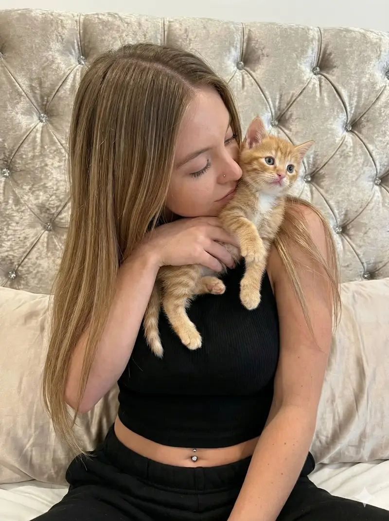 Preview of Tender Portrait of Woman Nuzzling a Kitten